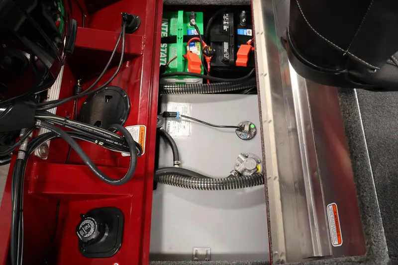 Slide: The Image of 2024 Tracker Pro Team 175 TXW boat interior showing battery compartment and wiring. - 27