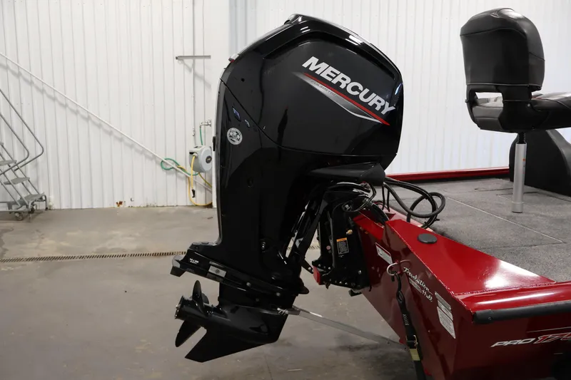 Slide: The Image of 2024 Tracker Pro Team 175 TXW with Mercury outboard motor in a garage setting. - 29
