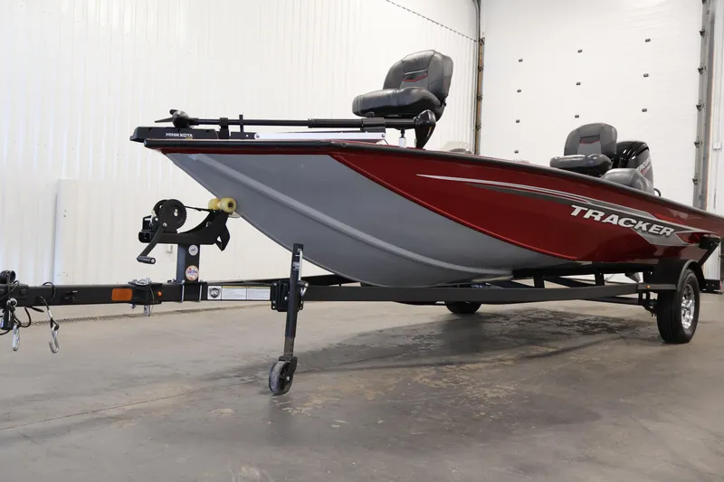 Slide: The Image of 2024 Tracker Pro Team 175 TXW boat in a showroom, featuring a sleek red design. - 34