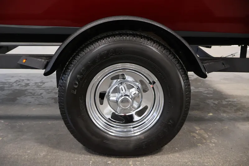 Slide: The Image of 2024 Tracker Pro Team 175 TXW trailer wheel with chrome rim and Loadstar tire. - 35
