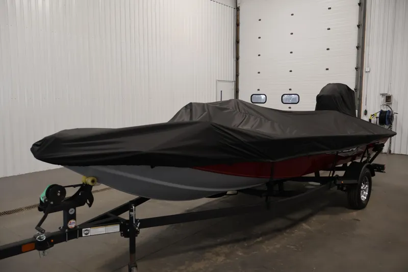 Slide: The Image of Open storage compartment in 2024 Tracker Pro Team 175 TXW boat, featuring carpeted interior. - 36
