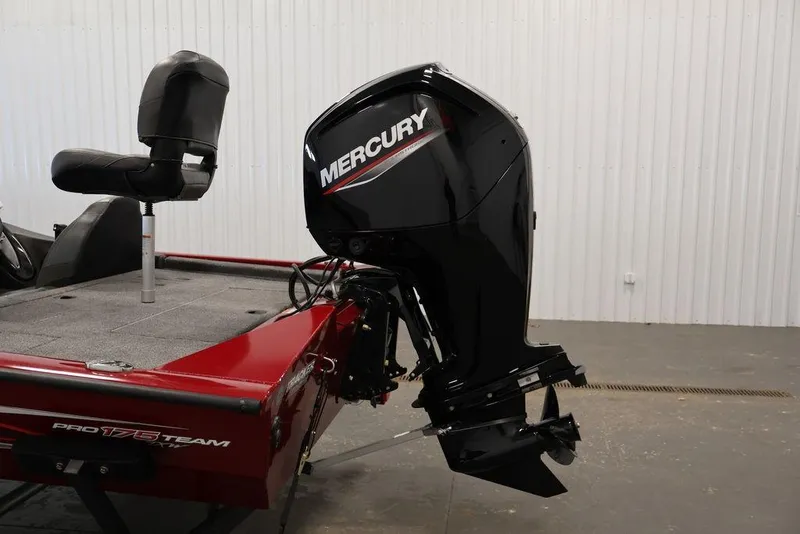 Slide: The Image of 2024 Tracker Pro Team 175 TXW boat with Mercury outboard motor in a garage. - 37
