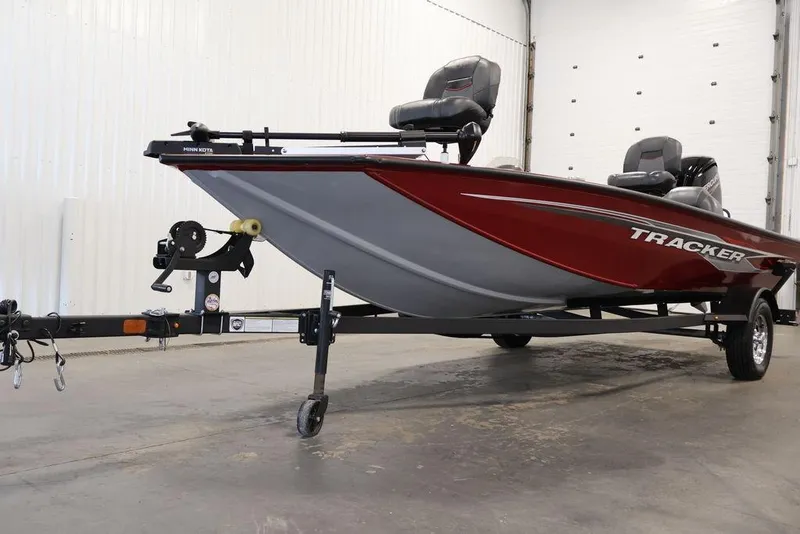 Slide: The Image of 2024 Tracker Pro Team 175 TXW boat in a showroom, featuring a sleek red design. - 44