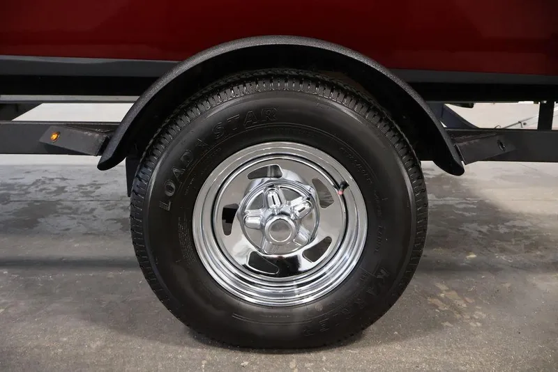 Slide: The Image of 2024 Tracker Pro Team 175 TXW trailer wheel with chrome rim and Loadstar tire. - 46