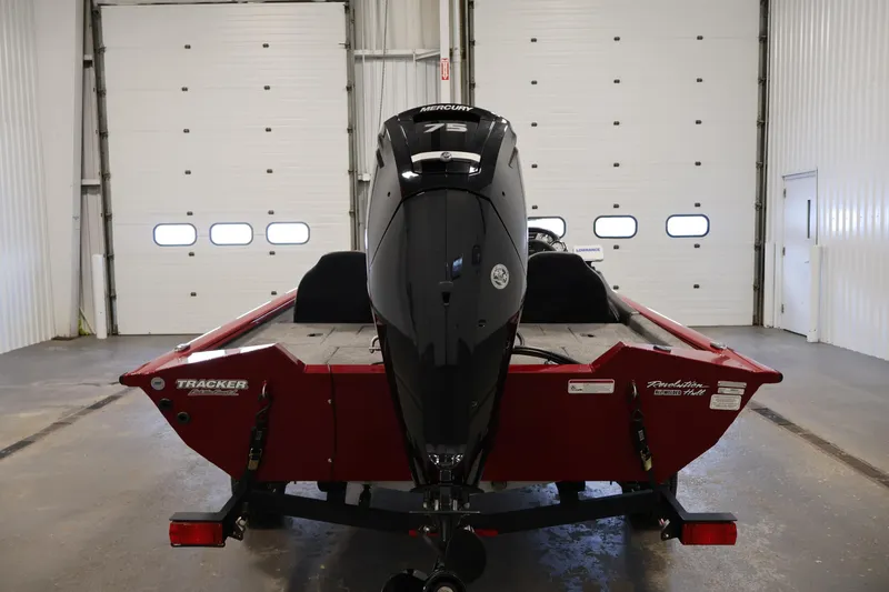 Slide: The Image of 2024 Tracker Pro Team 175 TXW boat with Mercury engine in a garage setting. - 5