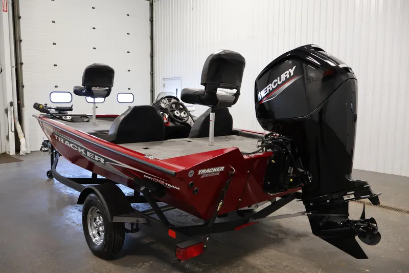 Slide: The Image of 2024 Tracker Pro Team 175 TXW boat with Mercury engine in a garage setting. - 6