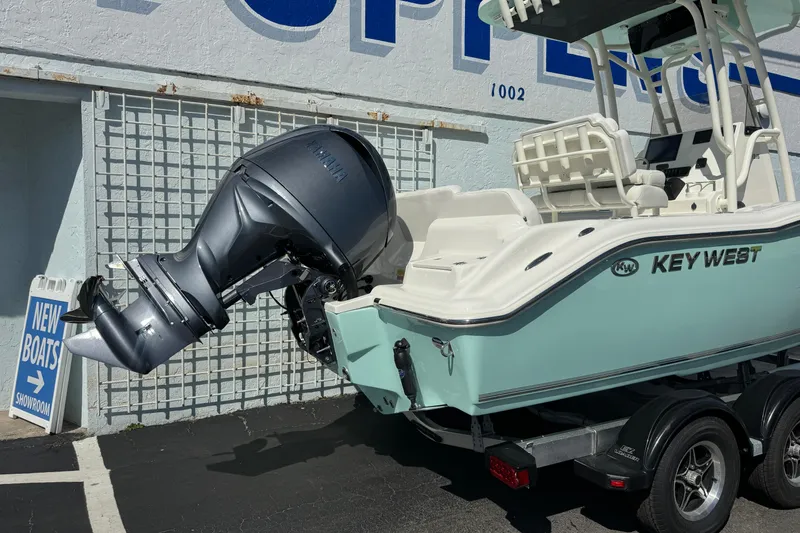 Slide: The Image of 2026 Key West 219 FS boat with Yamaha outboard motor in showroom. - 2
