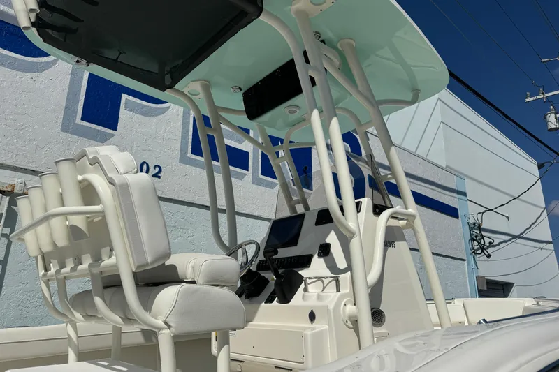 Slide: The Image of 2026 Key West 219 FS boat interior with white seating and modern console. - 3