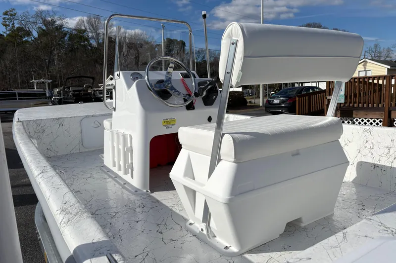 Slide: The Image of 2026 Coastal Skiff 171 boat interior with steering console and cushioned seating. - 10