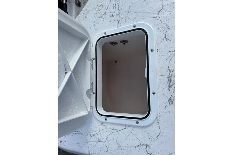 Slide: The Image of Open storage compartment on 2026 Coastal Skiff 171 boat, showing interior details. - 17