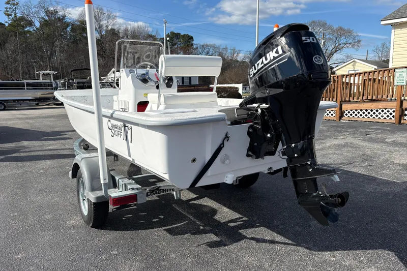 Slide: The Image of 2026 Coastal Skiff 171 boat with Suzuki 50 outboard motor on a trailer. - 4