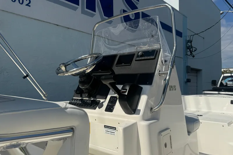 Slide: The Image of 2026 Key West 179 FS boat console with steering wheel and controls. - 3
