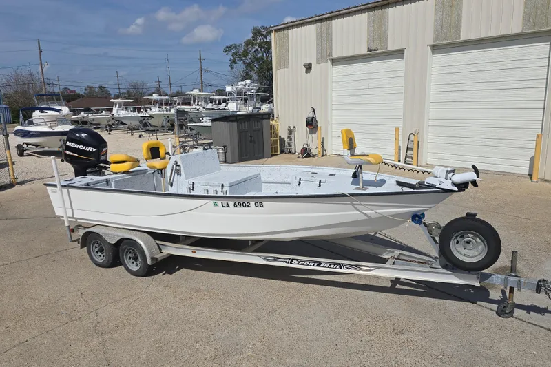 The Image of 2011 Reno Skiff 22 boat on trailer, parked outside a storage facility. - 1