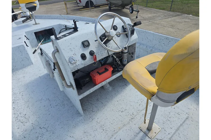 Slide: The Image of 2011 Reno Skiff 22 boat interior with steering wheel and yellow seat. - 11