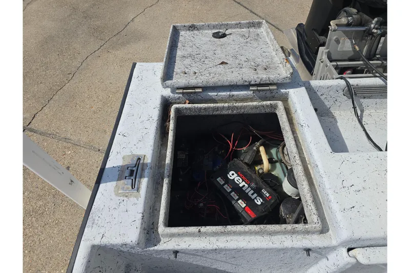 Slide: The Image of Open hatch of 2011 Reno Skiff 22 showing battery and wiring components. - 12