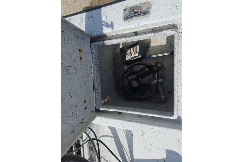 Slide: The Image of Open storage compartment of 2011 Reno Skiff 22 boat with tools and equipment inside. - 13