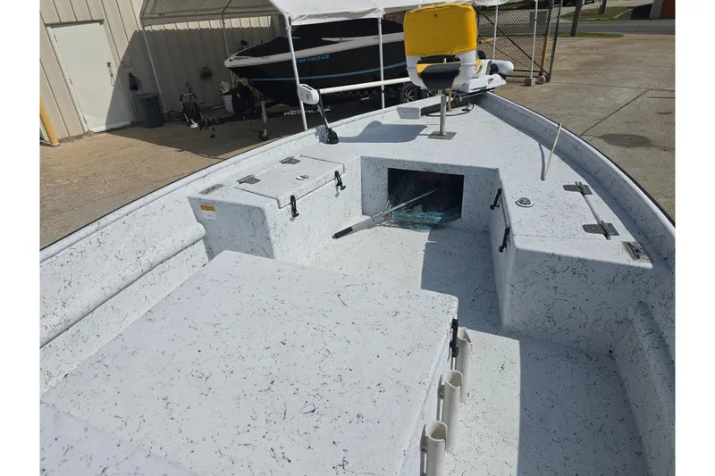 Slide: The Image of 2011 Reno Skiff 22 boat interior with storage compartments and seating. - 14