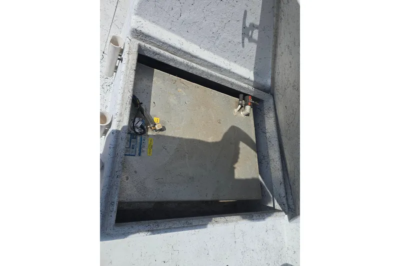 Slide: The Image of 2011 Reno Skiff 22 boat compartment with wiring and fittings. - 15