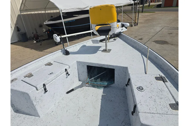 Slide: The Image of 2011 Reno Skiff 22 boat deck with storage compartments and seating. - 16