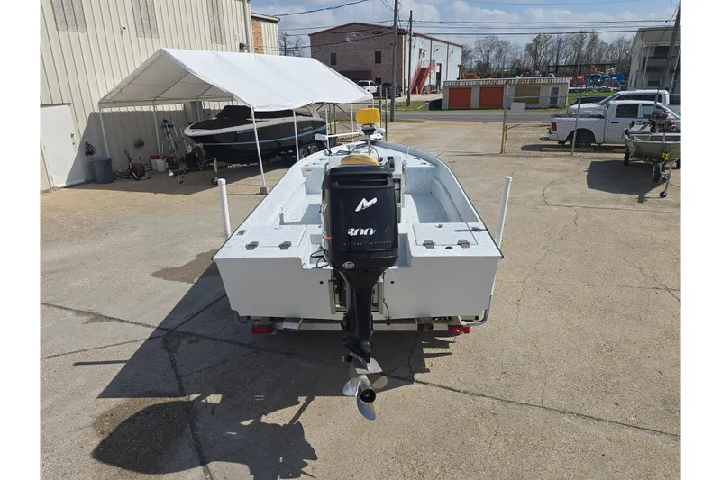 Slide: The Image of 2011 Reno Skiff 22 boat with outboard motor in a parking lot. - 4