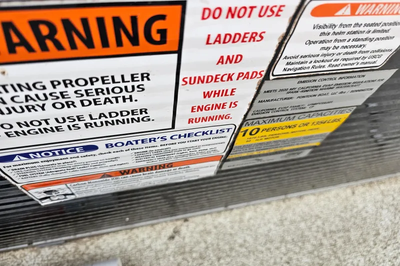 Slide: The Image of Warning labels on a 2020 Bennington SV 20 SFV boat, highlighting safety precautions. - 13