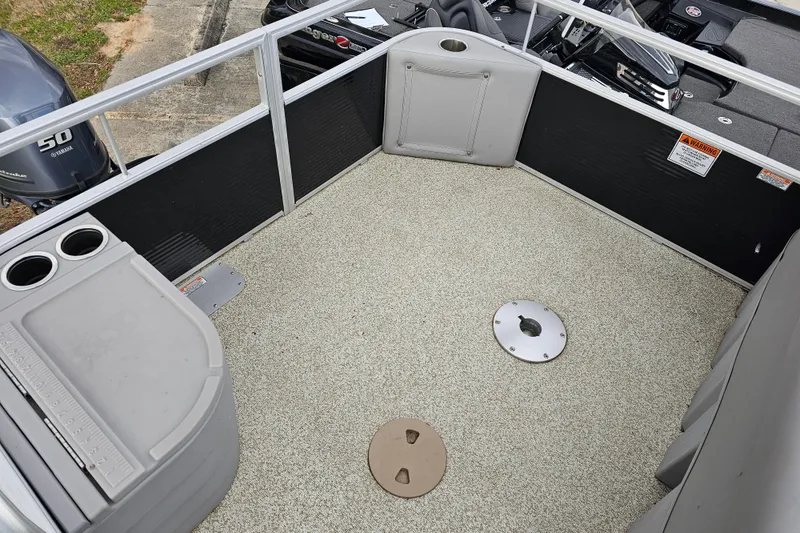 Slide: The Image of 2020 Bennington SV 20 SFV boat interior with carpeted deck and storage compartments. - 7