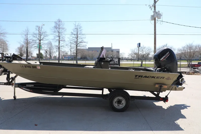 Slide: The Image of 2021 Tracker Grizzly 2072 SC All-Welded boat on trailer, side view. - 2