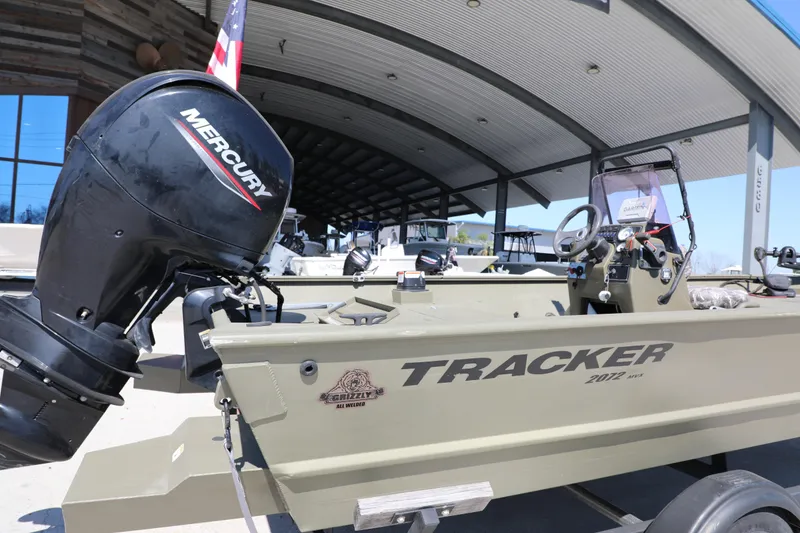 Slide: The Image of 2021 Tracker Grizzly 2072 SC All-Welded boat with Mercury engine displayed outdoors. - 3