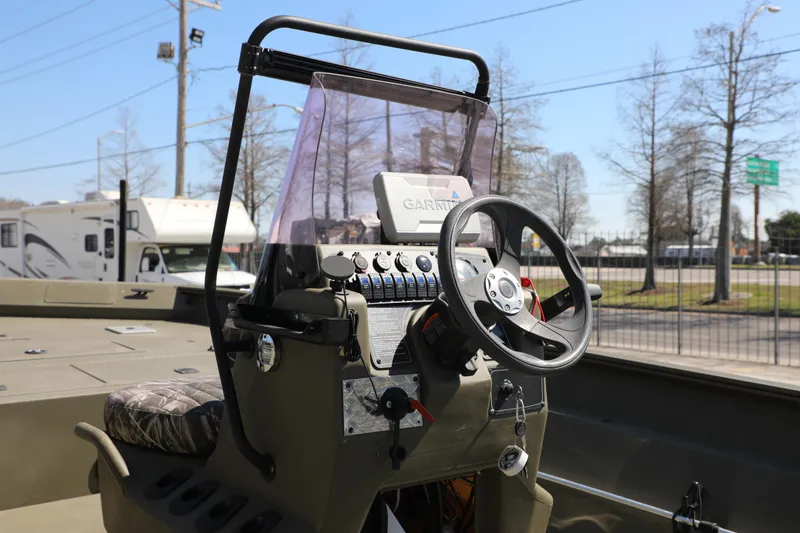 Slide: The Image of 2021 Tracker Grizzly 2072 SC boat console with steering wheel and Garmin device. - 9