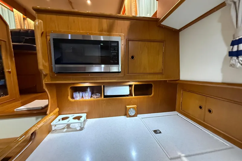 Slide: The Image of 2000 Grand Banks 43 Eastbay FB yacht kitchen with microwave and wooden cabinetry. - 100