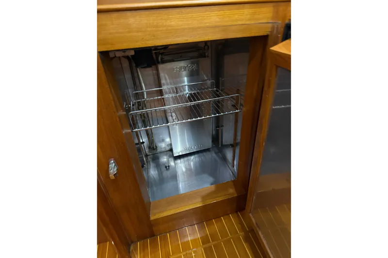 Slide: The Image of Wooden cabinet with stainless steel interior and wire shelf on 2000 Grand Banks 43 Eastbay FB. - 104