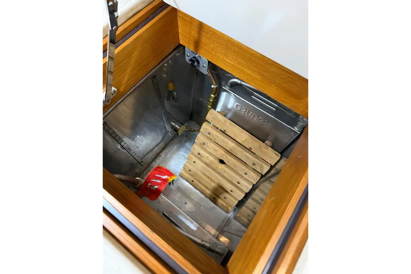 Slide: The Image of Engine compartment of 2000 Grand Banks 43 Eastbay FB with wooden slats and metal components. - 105