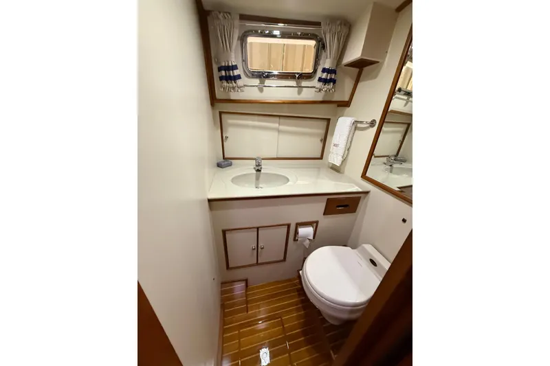 Slide: The Image of Bathroom interior of 2000 Grand Banks 43 Eastbay FB yacht, featuring sink and toilet. - 113