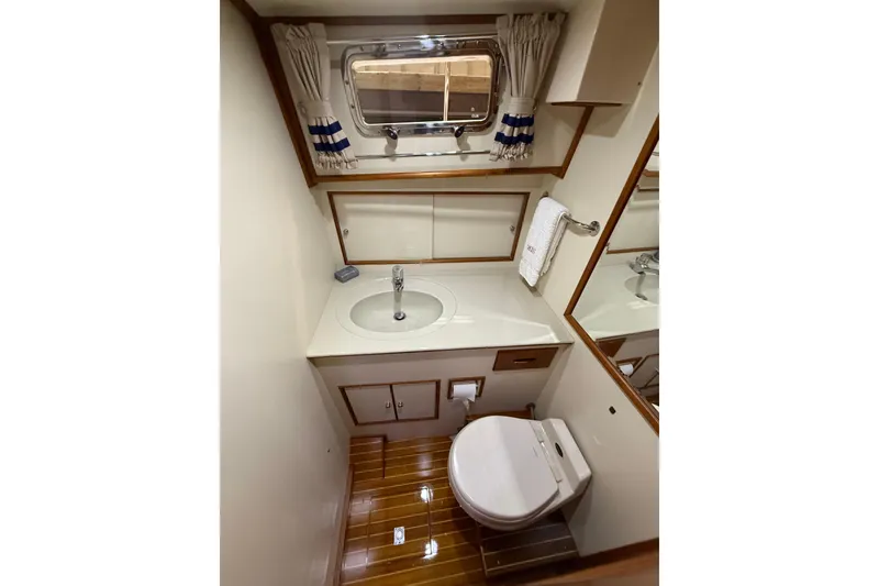 Slide: The Image of Bathroom interior of 2000 Grand Banks 43 Eastbay FB yacht, featuring sink and toilet. - 114