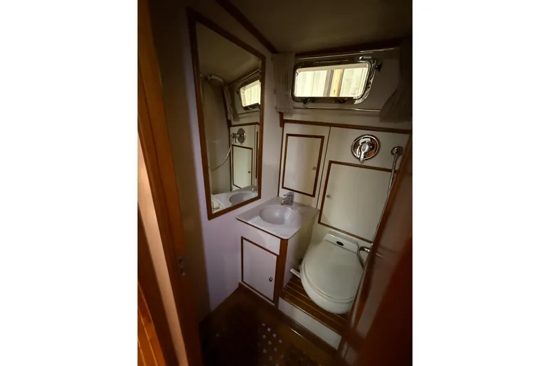 Slide: The Image of Bathroom interior of 2000 Grand Banks 43 Eastbay FB yacht, featuring sink and toilet. - 115