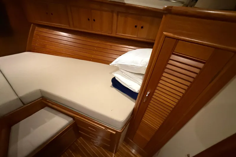 Slide: The Image of Cozy cabin interior of 2000 Grand Banks 43 Eastbay FB with wooden finish and bedding. - 120