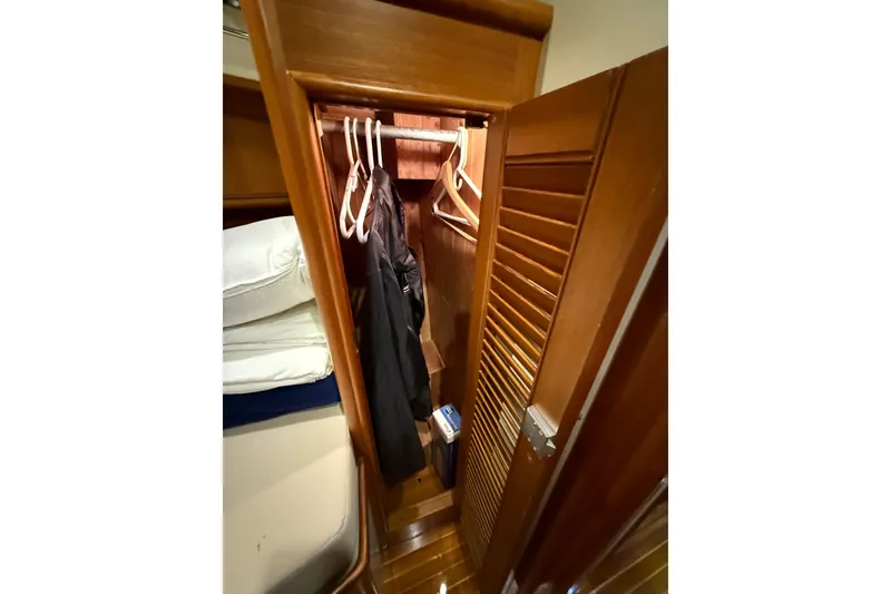 Slide: The Image of Wooden closet interior on 2000 Grand Banks 43 Eastbay FB yacht. - 123