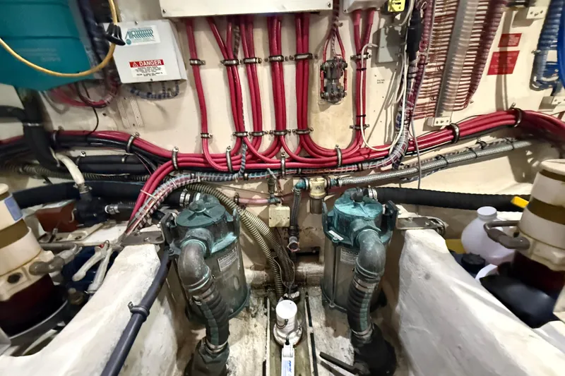 Slide: The Image of Engine room of 2000 Grand Banks 43 Eastbay FB with complex wiring and machinery. - 127