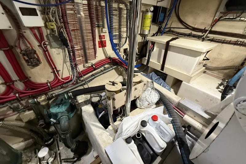 Slide: The Image of Engine room of 2000 Grand Banks 43 Eastbay FB with wiring and maintenance supplies. - 130