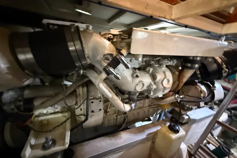 Slide: The Image of Engine room of 2000 Grand Banks 43 Eastbay FB yacht, showcasing detailed machinery components. - 131
