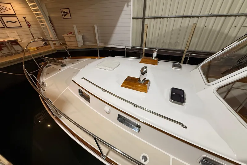 Slide: The Image of 2000 Grand Banks 43 Eastbay FB yacht docked indoors, showcasing sleek deck design. - 14