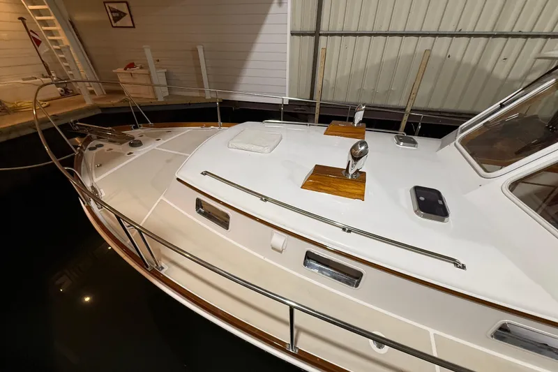 Slide: The Image of 2000 Grand Banks 43 Eastbay FB yacht docked indoors, showcasing sleek design and polished wood accents. - 16