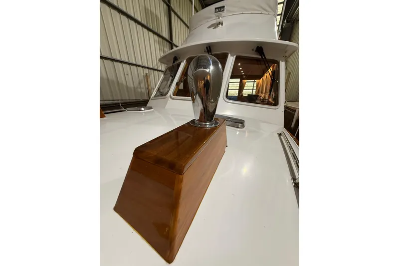 Slide: The Image of 2000 Grand Banks 43 Eastbay FB yacht with polished wood and chrome details in a marina. - 18