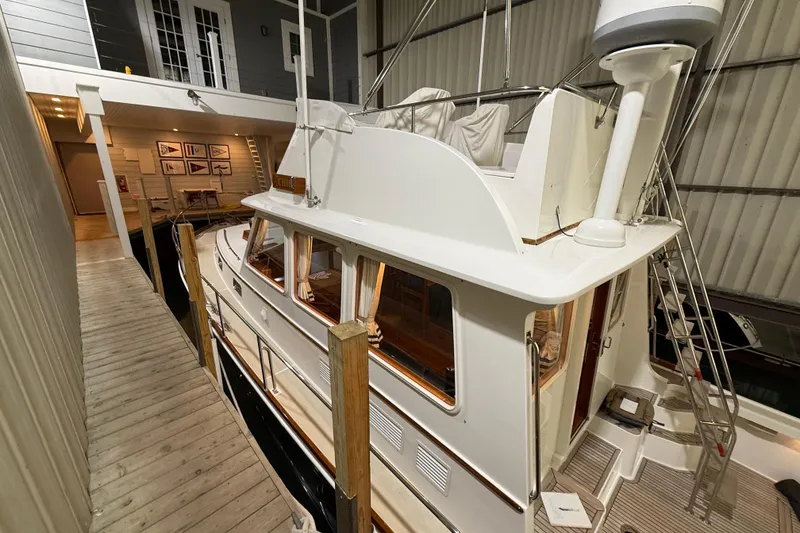 Slide: The Image of 2000 Grand Banks 43 Eastbay FB yacht docked indoors, showcasing elegant design and craftsmanship. - 19