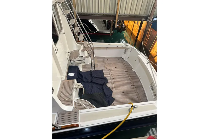 Slide: The Image of 2000 Grand Banks 43 Eastbay FB yacht docked indoors, showcasing elegant design. - 2