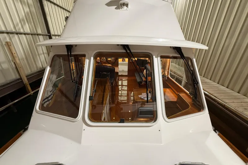 Slide: The Image of 2000 Grand Banks 43 Eastbay FB yacht in storage, showcasing cockpit and interior. - 22