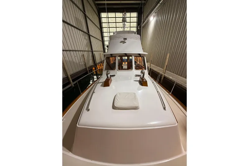 Slide: The Image of 2000 Grand Banks 43 Eastbay FB yacht in indoor storage, showcasing sleek design. - 24