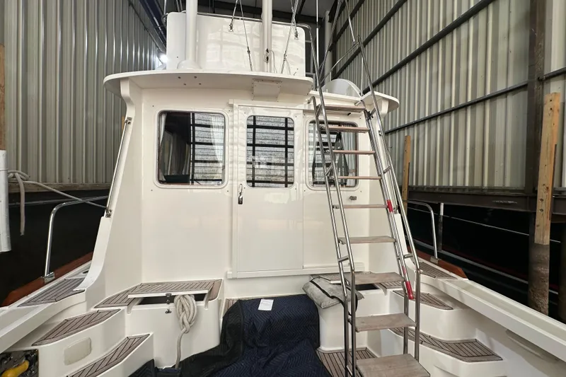 Slide: The Image of 2000 Grand Banks 43 Eastbay FB yacht docked indoors, showcasing elegant design and craftsmanship. - 3