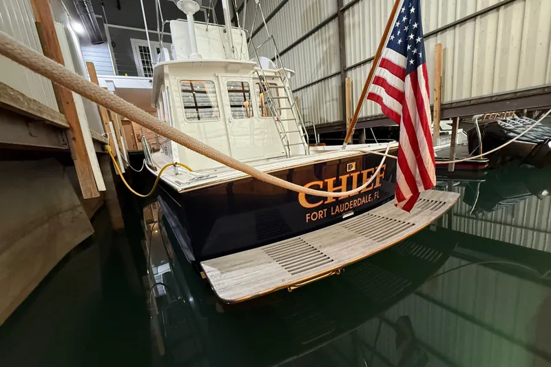 Slide: The Image of Grand Banks 43 Eastbay FB 2000 yacht docked indoors with American flag. - 32