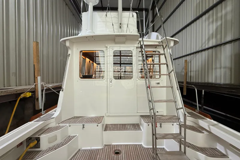 Slide: The Image of Grand Banks 43 Eastbay FB 2000 in warehouse with ladder. - 37